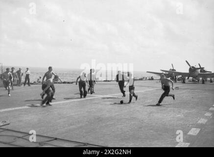 SPORT & FREIZEIT WÄHREND DES ZWEITEN WELTKRIEGS - Ein Spiel von Flight Deck Soccer, gespielt mit einem Rag Ball, an Bord des Flugzeugträgers HMS INDOMITABLE, als sie von dem Fleet Air Arm RAID auf Padang, Sumatra Royal Navy, HMS Indomitable, Aircraft Carrier, (1940) zurückkehrte Stockfoto