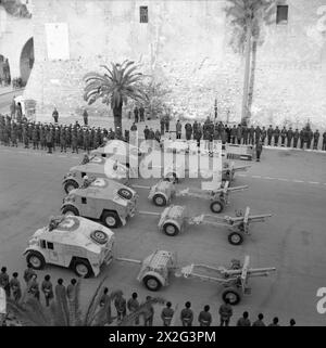 25-Pfünder-Feldgeschütze und Quad-Artillerietraktoren der britischen Armee passieren Winston Churchill in Tripolis am 4. Februar 1943, um den Erfolg der 8. Armee im nordafrikanischen Feldzug zu feiern. Stockfoto