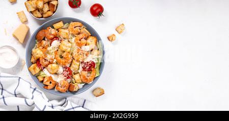 Shrimps Caesar Salat in einer Schüssel mit Parmesankäse, Salat, Dressing und Croutons Stockfoto