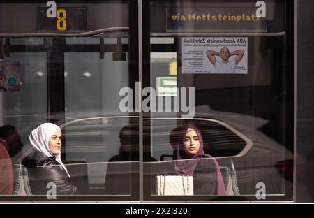 Basel, Schweiz - 18. April 2024: Junge muslimische Frauen im Hijab sitzen auf einem Fenstersitz, während sie in einer Straßenbahn Nr. 8 fahren Stockfoto