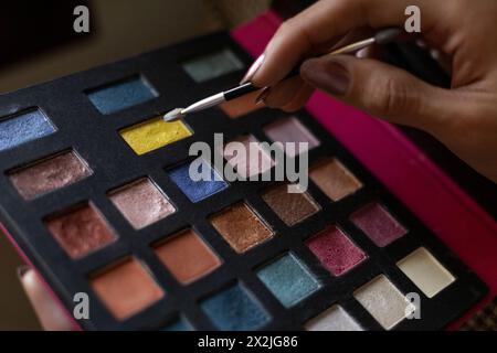 Junger Transgender-Mann (22) ist in seinem Zimmer und zeigt sein Make-up. Transgender-Konzept Stockfoto