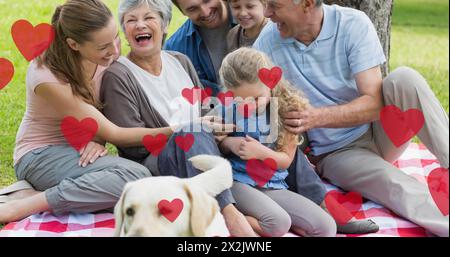 Bild von Herzsymbolen, die über einem Hund mit kaukasischer Familie schweben Stockfoto