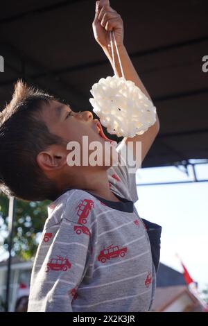 Kinder nehmen an einem Cracker-Ess-Wettbewerb zum Gedenken an Indonesiens Unabhängigkeitstag Teil Stockfoto