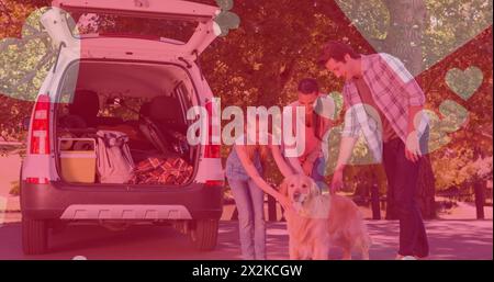 Bild von Herzsymbolen, die über einem Hund mit kaukasischer Familie schweben Stockfoto