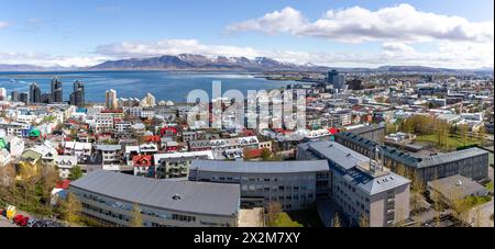 Reykjavik, Island, Panoramablick auf die Stadt mit farbenfrohen Wohngebäuden, Meerblick und schneebedeckten Berg Esjan. Stockfoto