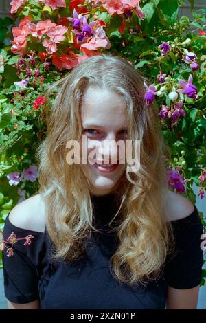 Junge lächelnde, hübsche, natürliche blonde Frau saß vor dem Red Lion Pub chalton hampshire england 1990er Jahre Stockfoto