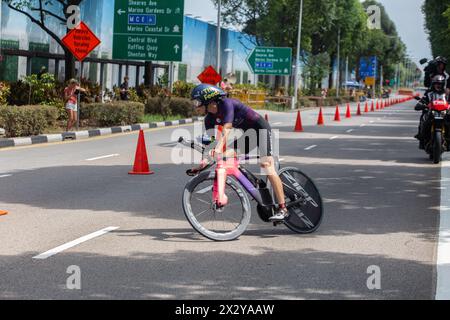 13. April 2024. T100-Triathlon-Event mit weiblicher Athletik auf ihrem sportlichen Rennrad, das eine Kehrtwende macht. Singapur Stockfoto