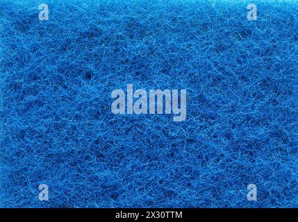 Textur eines blauen Kunststofffaserschwamms, Konzept für umweltschädliche Produkte, DATUM NICHT ANGEGEBEN Stockfoto