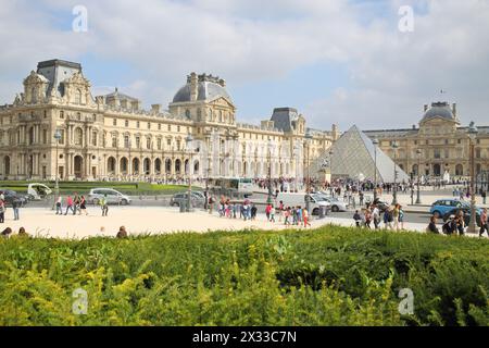 PARIS, FRANKREICH - 11. September 2014: Viele Touristen rund um den Königspalast und die Glaspyramide des Louvre Stockfoto