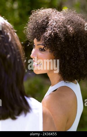 Birassische junge Frau unterhält sich mit ihrer Reifen Mutter im Garten Stockfoto