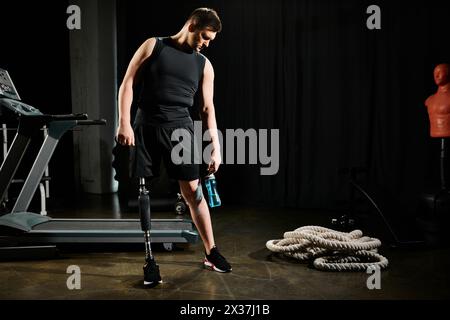 Ein Mann mit einer Beinprothese steht neben einer komplizierten Maschine in einem schwach beleuchteten Raum und erforscht sein kompliziertes Design. Stockfoto