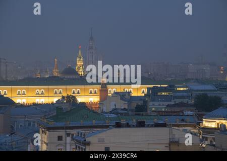 Teil des Arsenalgebäudes, der Dächer und des Spasskaya-Turms mit nächtlicher Belebung in Moskau, Russland Stockfoto