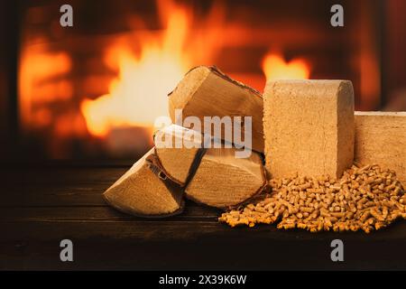 Biomasseheizung. Brennholz, Pellets und Briketts auf Holzkaminhintergrund. Nachhaltige, CO2-neutrale und erneuerbare Kraftstoffe Stockfoto