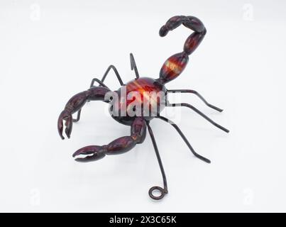 Metall-Wandkunst einer Skorpion-Arachnide, rot, violett, tiefbraune Farbe mit Zangenklauen und Schwanz oben, isoliert auf weißem Hintergrund. Zum Aufhängen gemacht Stockfoto