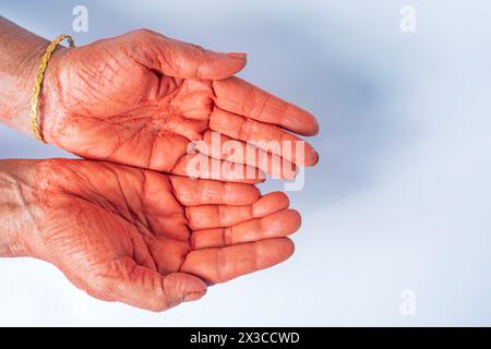 Hände einer Indianerin mit rotem holi-Pulver auf Hand isoliert auf weißem Hintergrund. Draufsicht Stockfoto