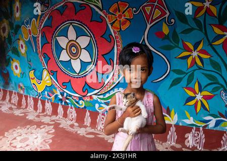 Chapainawabganj, Rajshahi, Bangladesch. April 2024. Fast alle Häuser in einem Dorf in Bangladeschs nordwestlichem Viertel Chapainawabganj sind mit der südasiatischen traditionellen Kunst namens „Alpona“ geschmückt. Die Kunst wird traditionell von Frauen praktiziert. Das Dorf ist im Land als „Alpona Gram“ (Kunstdorf) bekannt. Santals lebten schon sehr lange im Norden dieses Landes. Die Farben und Muster, die sie unter ihnen vorenthalten, und die Kultur, die sie haben, sind sehr unterschiedlich und sehr hell im Vergleich zu den vielen anderen ethnischen Menschen, die in diesem Land leben. Die lebendigste Stockfoto