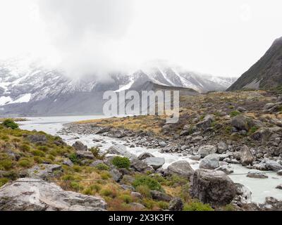 Erkunden Sie den atemberaubenden Hooker Valley Track mit schneebedeckten Bergen in Neuseeland, wo die Schönheit der Natur keine Grenzen kennt Stockfoto