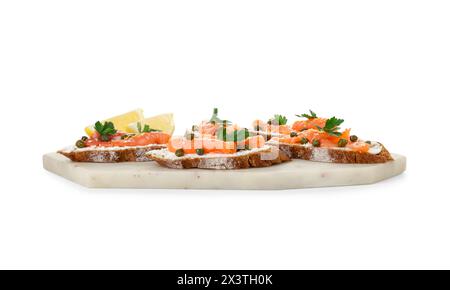 Leckere Kanapees mit Lachs, Kapern, Zitrone und Frischkäse isoliert auf weiß Stockfoto