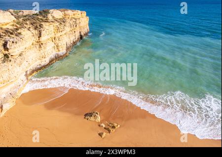 Blick von oben auf das Meer und Wellenbrecher am Sandstrand in der Nähe von Albufeira, Algarve, Portugal Stockfoto