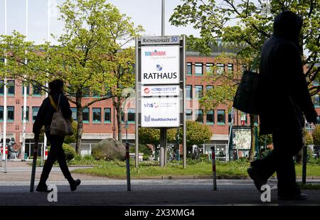 Norderstedt, Deutschland. April 2024. Passanten gehen entlang der Rathausallee. Das Rathaus ist im Hintergrund zu sehen. Quelle: Marcus Brandt/dpa/Alamy Live News Stockfoto