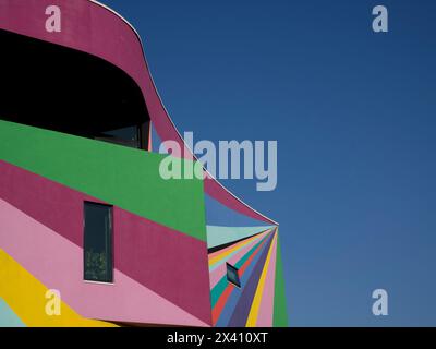 Außenwände einer Kunstgalerie, die an einem sonnigen Tag in leuchtenden Farben vor blauem Himmel gemalt ist; Eastbourne, East Sussex, England Stockfoto