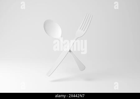 Weiße Gabel und Löffel schwebend in der Luft auf weißem Hintergrund in Monochrom und Minimalismus. Konzept von Besteck, Gourmetessen, Köchen und Restaurants Stockfoto