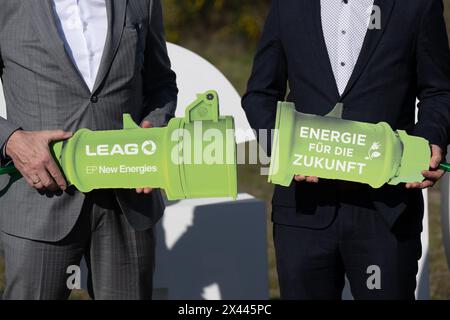 30. April 2024, Sachsen, Boxberg: Thorsten Kramer (links), CEO von Leag, und Dominique Guillou, Geschäftsführer von EP New Energies, halten bei der Eröffnung einer bodenmontierten Photovoltaikanlage (PV-Park) vor dem Kraftwerk Boxberg einen symbolischen Netzstecker. Der Park ist Teil der Leag Gigawatt Factory. Foto: Sebastian Kahnert/dpa Stockfoto