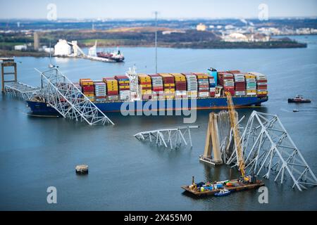 Dundalk, Vereinigte Staaten von Amerika. März 2024. Blick von einem MH-60 Jayhawk-Hubschrauber der Küstenwache auf den verwickelten Frachtträger MV Dali, der in den Stahlträgern der eingestürzten Francis Scott Key Bridge, die den Kanal Fort McHenry blockiert, am 29. März 2024 in der Nähe von Dundalk, Maryland, eingehüllt ist. Die Brücke wurde am 26. März von einem 984-Fuß-Containerschiff getroffen und stürzte zusammen, wobei sechs Arbeiter ums Leben kamen. Quelle: PO1 Brandon Giles/US Coast Guard/Alamy Live News Stockfoto