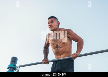 Männlicher Athlet, der draußen in einer Bar taucht Stockfoto