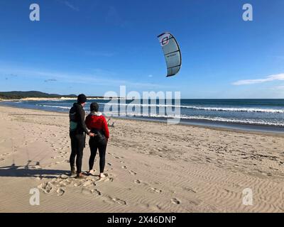 Cabedelo, Viana do Castelo, Portugal - 29. April 2024: Ein Kitesurflehrer führt einen Trainee durch die Kitesperre am Cabedelo Beach, Por Stockfoto