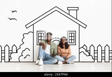 Ehepartner sitzen auf dem Boden vor der Hauszeichnung Stockfoto
