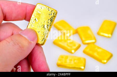 Nahhand mit Goldbarren isoliert auf weißem Hintergrund Stockfoto