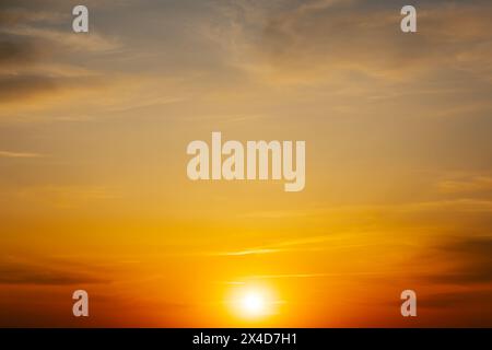 Majestätische Dämmerung. Wunderschöner, warmer blauer Himmel mit lebhaften Goldtönen. Dichte Wolken im Morgenhimmel. Bewölkter, heller Himmel am Abend. Abstrakt Stockfoto