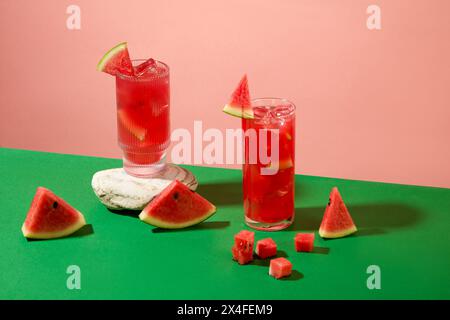 Farbiger Hintergrund für Werbung für Getränke mit zwei Glasbecher Wassermelonensaft. Vorderansicht und Kopierbereich. Wassermelone ist ein guter Sauer Stockfoto