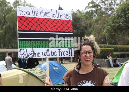 Nicht exklusiv: Eine Studentin der Universidad Nacional Autonoma de Mexico (UNAM) hält ein Plakat vor einem Zelt in einem Lager, um gegen Th zu protestieren Stockfoto