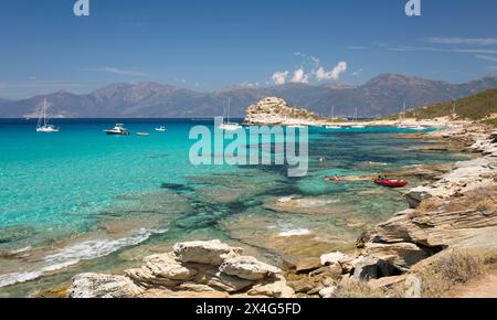 Saint-Florent, Haute-Corse, Korsika, Frankreich. Blick über klares türkisfarbenes Wasser auf die Halbinsel Cap Corse von der felsigen Küste in der Nähe der Plage du Loto. Stockfoto