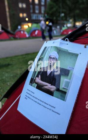 Anhänger der Universitätsbesetzung hinterlassen ein Foto von Ayman Jerjawi, einem medizinischen Mitarbeiter, der in Gaza während einer Mahnwache für medizinisches Personal in Palästina in einem der Zelte getötet wurde. Studenten und Unterstützer besetzen den Brunswick Park an der Manchester University. Die Demonstranten fordern, dass die Universität aufhört, Israel zu bewaffnen und ihre Mittäterschaft am Völkermord zu beenden. Sie bestehen darauf, dass die Universität ihre Partnerschaft mit dem Waffenhersteller BAE Systems beendet, ihre Beziehungen zu Tel Aviv und den Hebräischen Universitäten in Israel beendet und eine Politik verfolgt, die sicherstellt, dass alle Forschungsarbeiten ethisch sind und nicht zum Waffenhandel beitragen. Protest Stockfoto