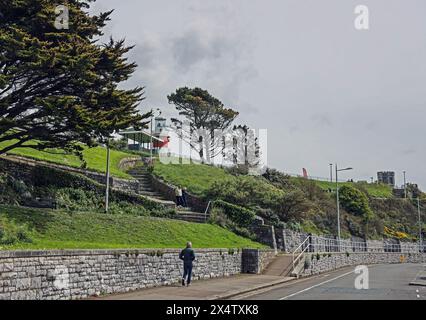 Plymouth Hoe von der Hoe Road mit den Ufern des öffentlichen Grünraums und dem Smeaton’s Tower. Es ist früh und relativ verlassen. Header und Stockfoto