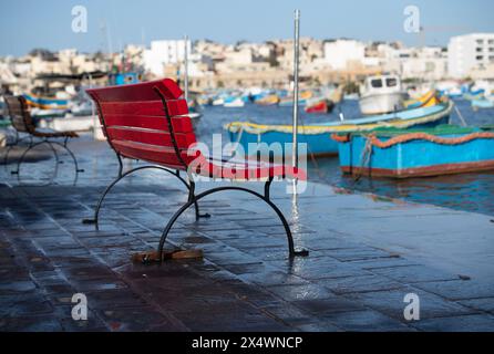 Stadtansicht am Wasser mit traditionellen Luzzu-Booten, die im Hafen von Marsaxlokk, Malta, ankern Stockfoto