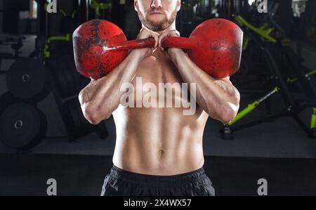 Muskulöser Mann hebt eine schwere Hantel während eines Workouts im Fitnessstudio. Sportkonzept, Fettverbrennung und gesunder Lebensstil. Stockfoto