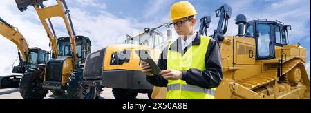 Der Mann kontrolliert den Fuhrpark gelber Baumaschinen Stockfoto