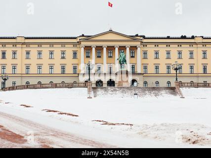 Fassade des neoklassizistischen Oslo Königspalastes im Winter mit norwegischem Standard fliegende und reitende Statue von König Carl Johan, Oslo, Norwegen Stockfoto