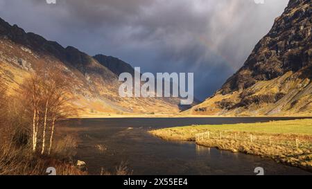 Regenbogen über Loch Achtriochtan in den schottischen Highlands, Glencoe, Schottland. Frühjahr (März) 2024. Stockfoto
