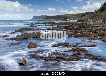 Blick über felsige Felsvorsprünge in Richtung Fair Head, Ballycastle Beach, Ballycastle, County Antrim, Nordirland. Frühjahr (März) 2024. Stockfoto