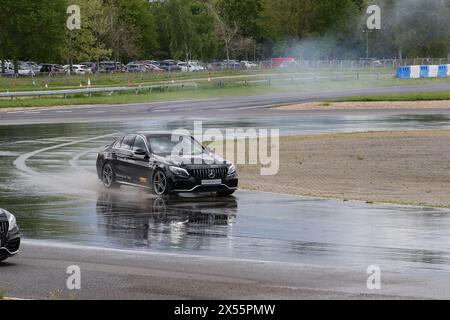 Mercedes-Benz C63 AMG fährt auf einer Gleitwanne bei Mercedes Benz World in Weybridge, Surrey, Großbritannien Stockfoto