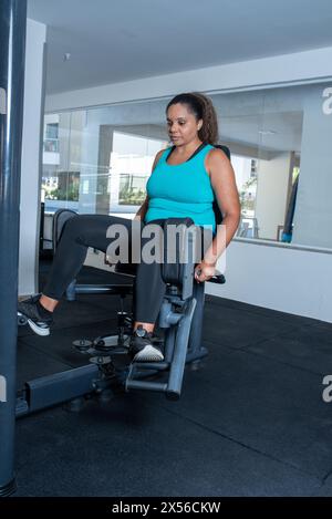 Sportliche Frau mit Multistation im Fitnessstudio. Fitness-Training im Fitnessstudio Stockfoto