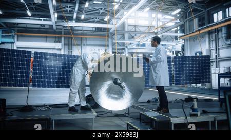 Team von Ingenieuren, die an Satellitenbau arbeiten. Aerospace Agency Spaceship Manufacturing Factory: Diverse Gruppe von Wissenschaftlern entwickelt Raumfahrzeuge für das globale Weltraumforschungsprogramm Stockfoto