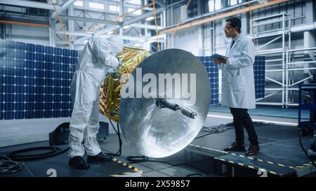 Ingenieur und Techniker, die an der Satellitenkonstruktion arbeiten. Luft- und Raumfahrtbehörde: Ein Team von Wissenschaftlern, das technologische Ausrüstung und Tablet-Computer zur Entwicklung von Raumfahrzeugen für die Weltraumforschung nutzt Stockfoto