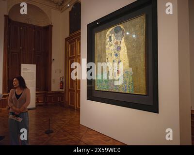 Wien, Österreich - 28. Juli 2023: Innenausstattungen im Schloss Belvedere. Barockpalast. Besucher in den Museumsräumen sehen das berühmte Leinwandbild Kiss von Gustav Klimt Stockfoto