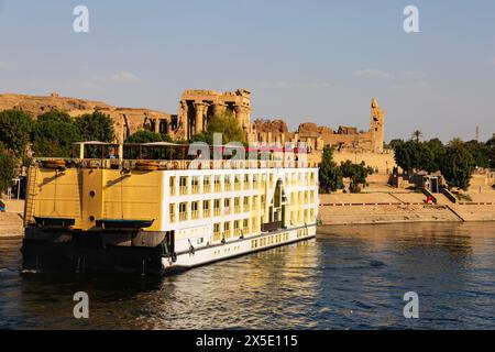 Nilkreuzschiff nähert sich dem Anlegeplatz am ptolemäischen Tempel von KOM Ombo am Ufer des Nils in Assuan, Ägypten. Stockfoto